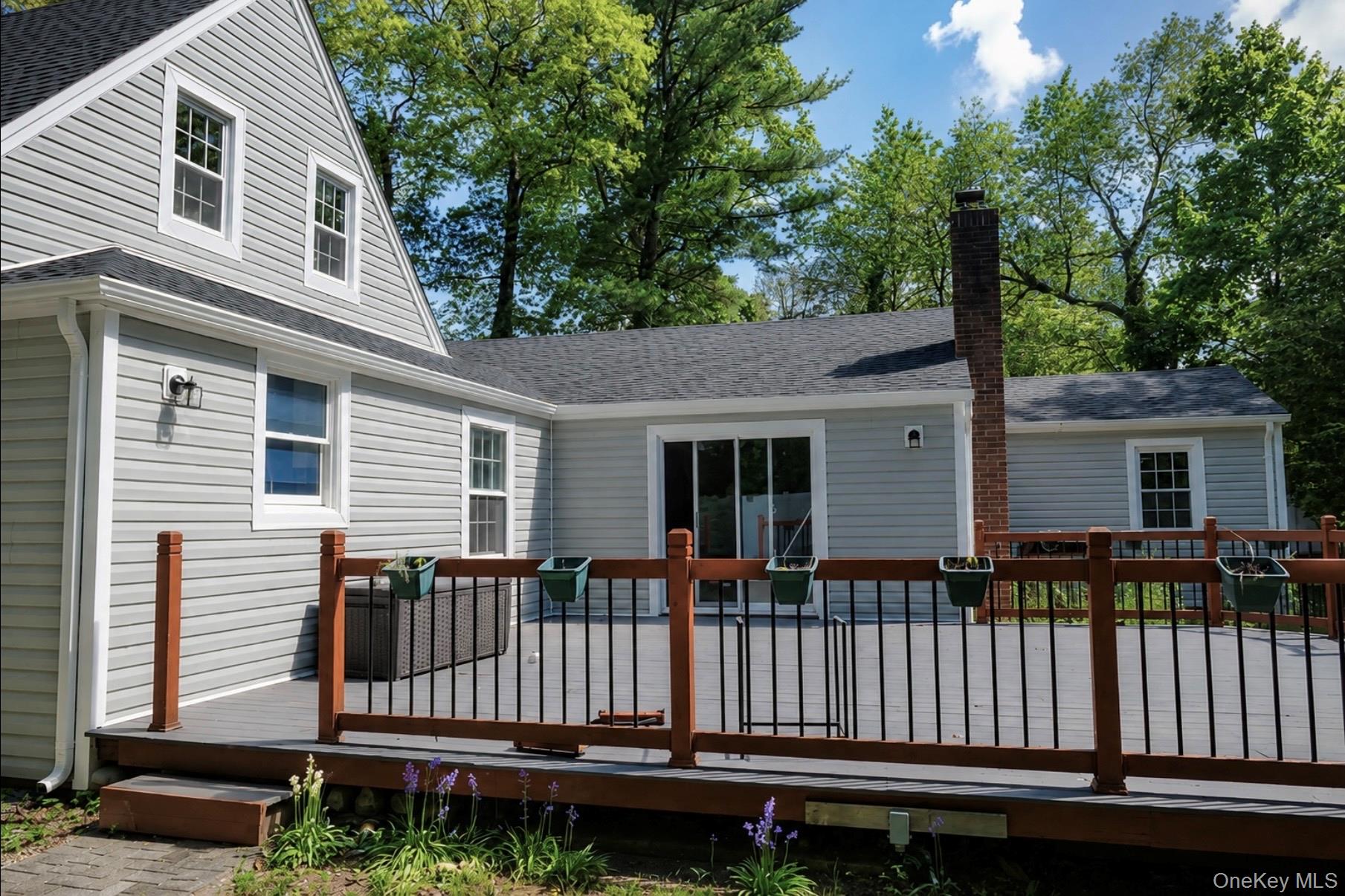 80 Mt Pleasant Road Smithtown, NY 11787 - Photo 19 of 27 a view of a house with wooden fence and a porch