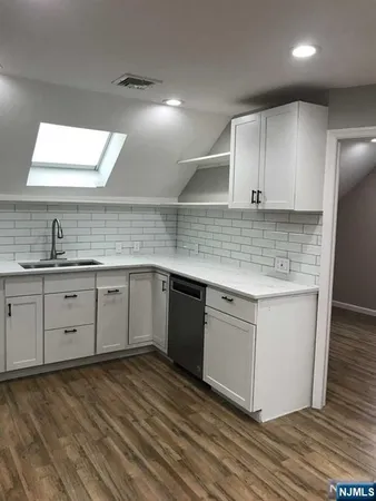 a kitchen with a sink cabinets and window