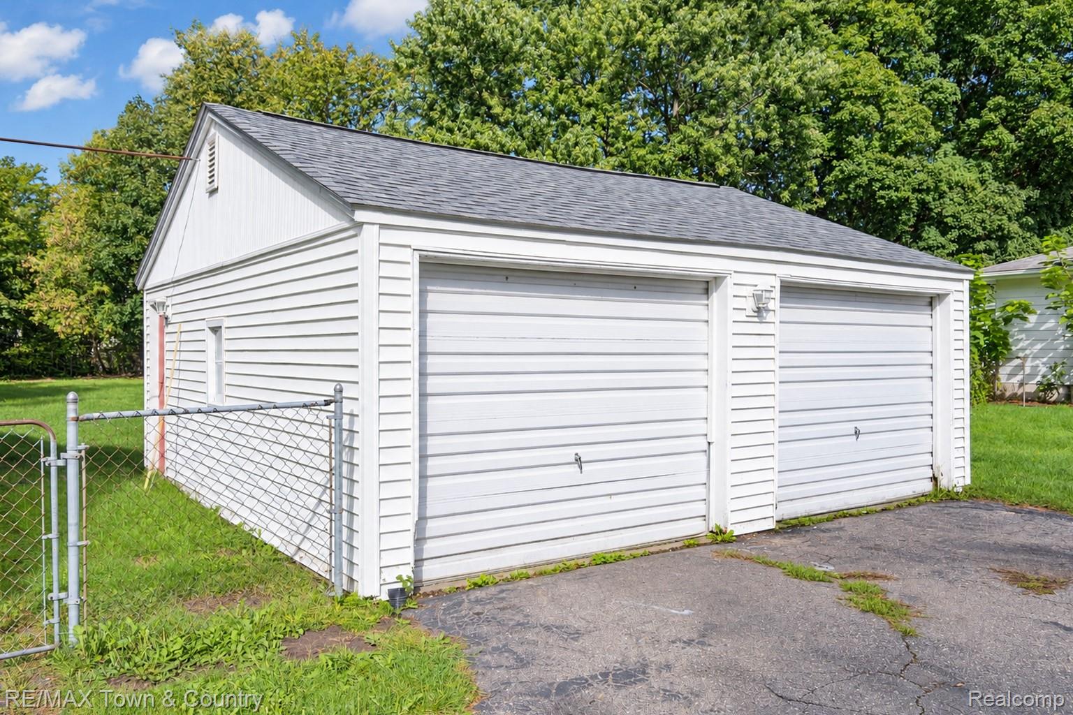 300 Elms Road Flushing, MI 48433 - Photo 18 of 26 Two-car detached garage with white siding and an asphalt shingle roof