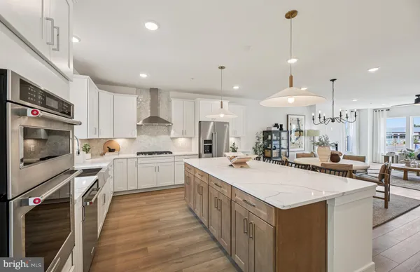 a kitchen with a stove a sink and a refrigerator