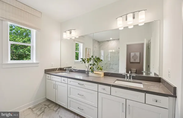 a bathroom with a double vanity sink and a mirror