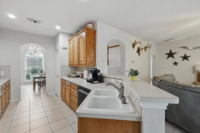 a kitchen with a sink appliances and cabinets