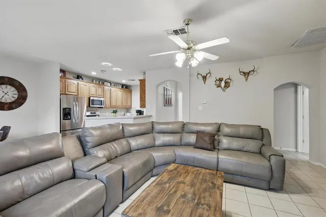 a living room with furniture and a chandelier