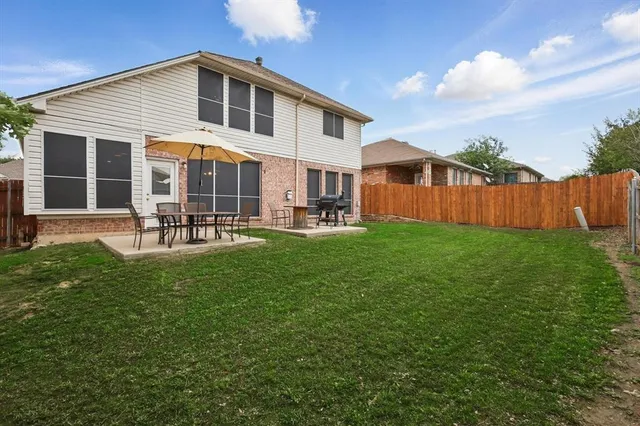 a front view of house with a garden and patio
