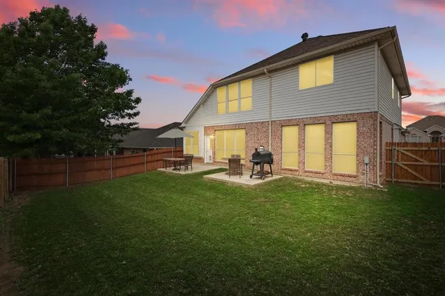 a view of backyard of house with green space