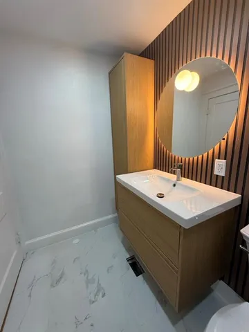 a bathroom with a sink and mirror
