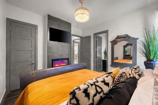 a bedroom with a bed and a flat screen tv