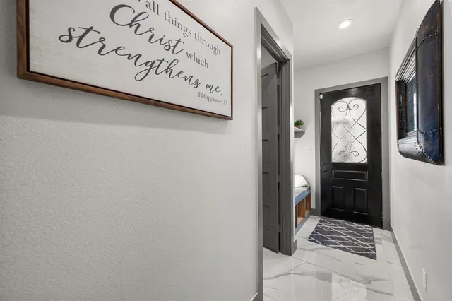 a view of a hallway with wooden door