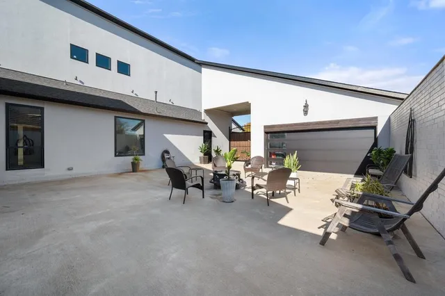 a view of a patio with a table and chairs