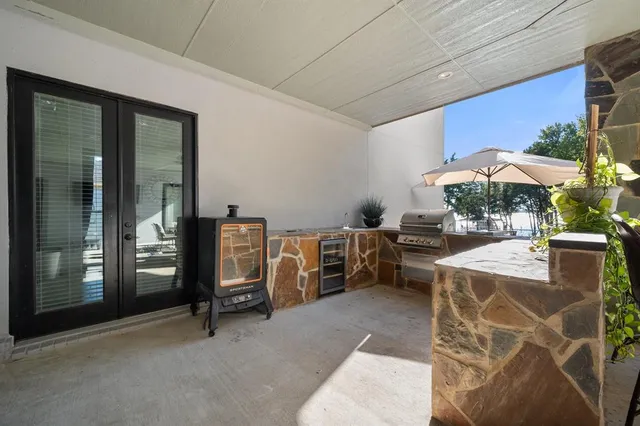 a view of a patio with table and chairs under an umbrella