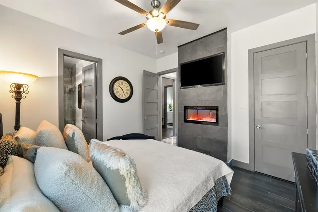 a bedroom with a large bed and a chandelier