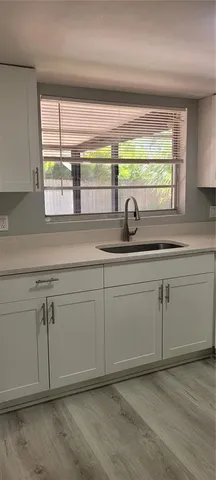 a stove top oven sitting inside of a kitchen