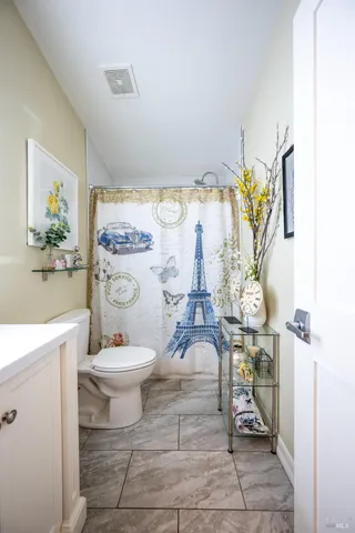 a bathroom with a sink toilet and a mirror
