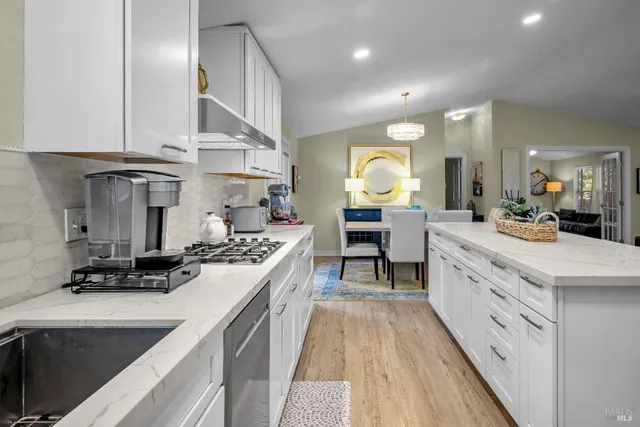 a kitchen with stainless steel appliances a refrigerator sink and cabinets