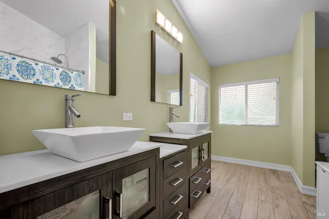 a bathroom with a sink vanity and mirror