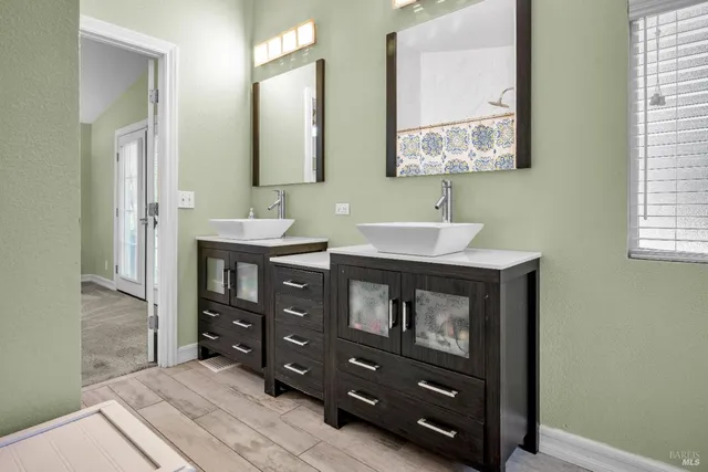 a bathroom with a sink double vanity and a mirror