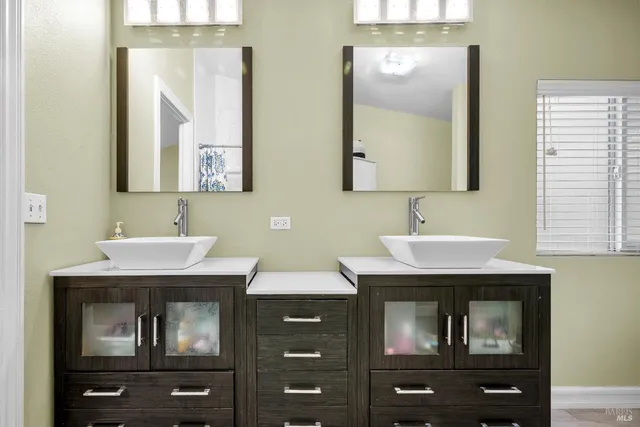 a backyard of a house with barbeque oven and outdoor seating