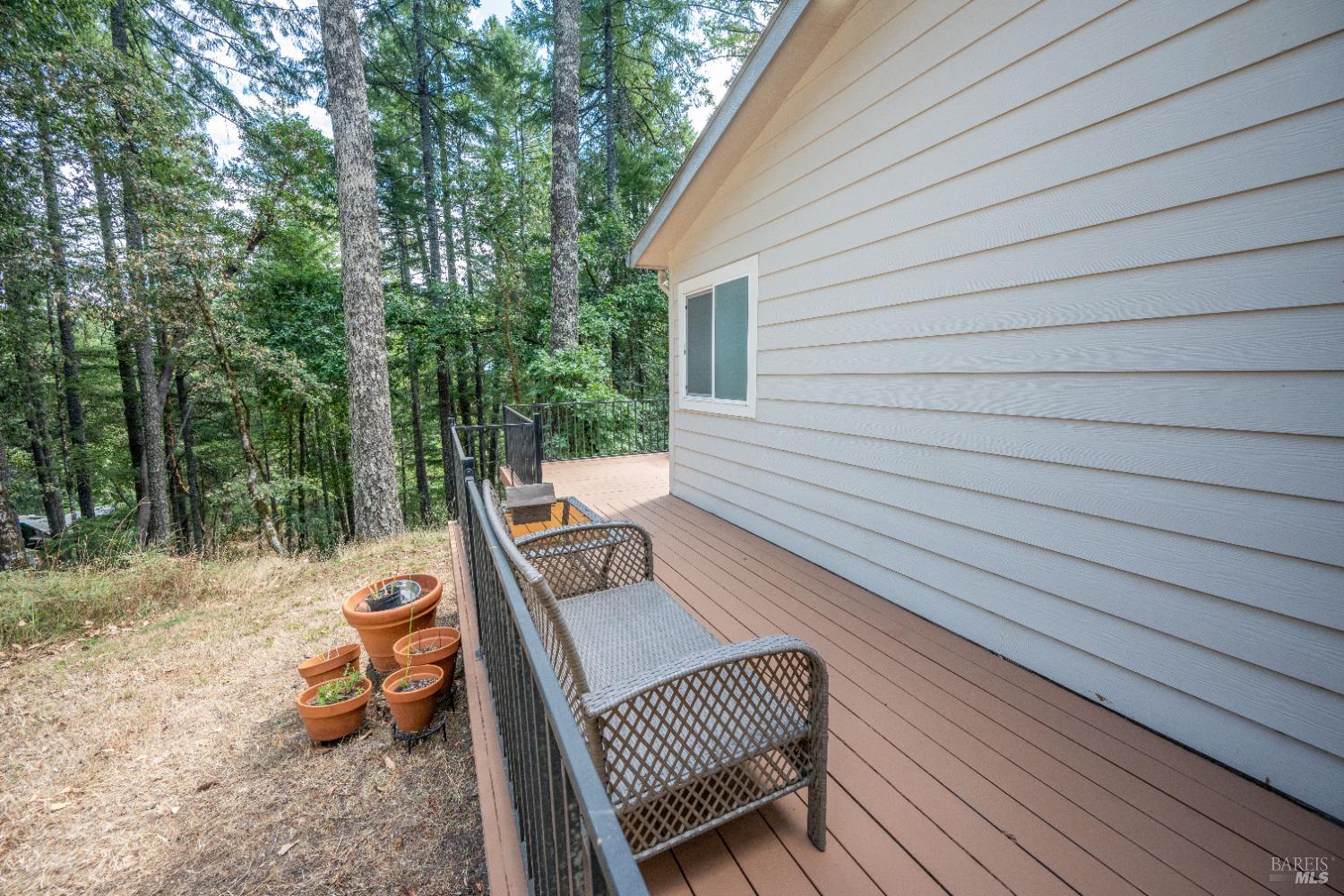 22945 Ridge Road Willits, CA 95490 - Photo 26 of 48 a view of a wooden deck with a bench