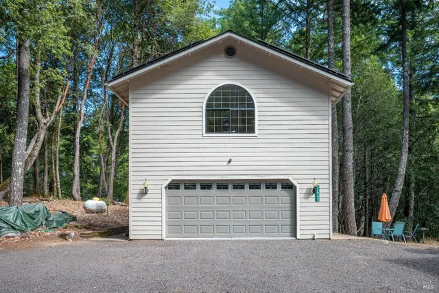 a view of backyard with outdoor seating and plants