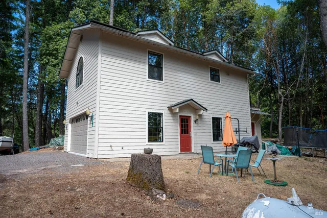 a view of backyard with green space and seating area