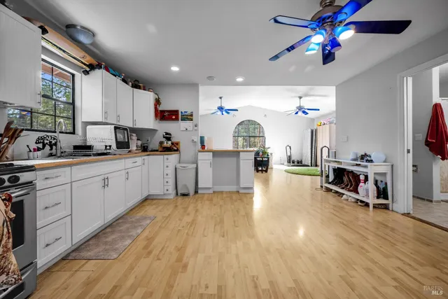 a kitchen with stainless steel appliances kitchen island granite countertop a refrigerator and microwave