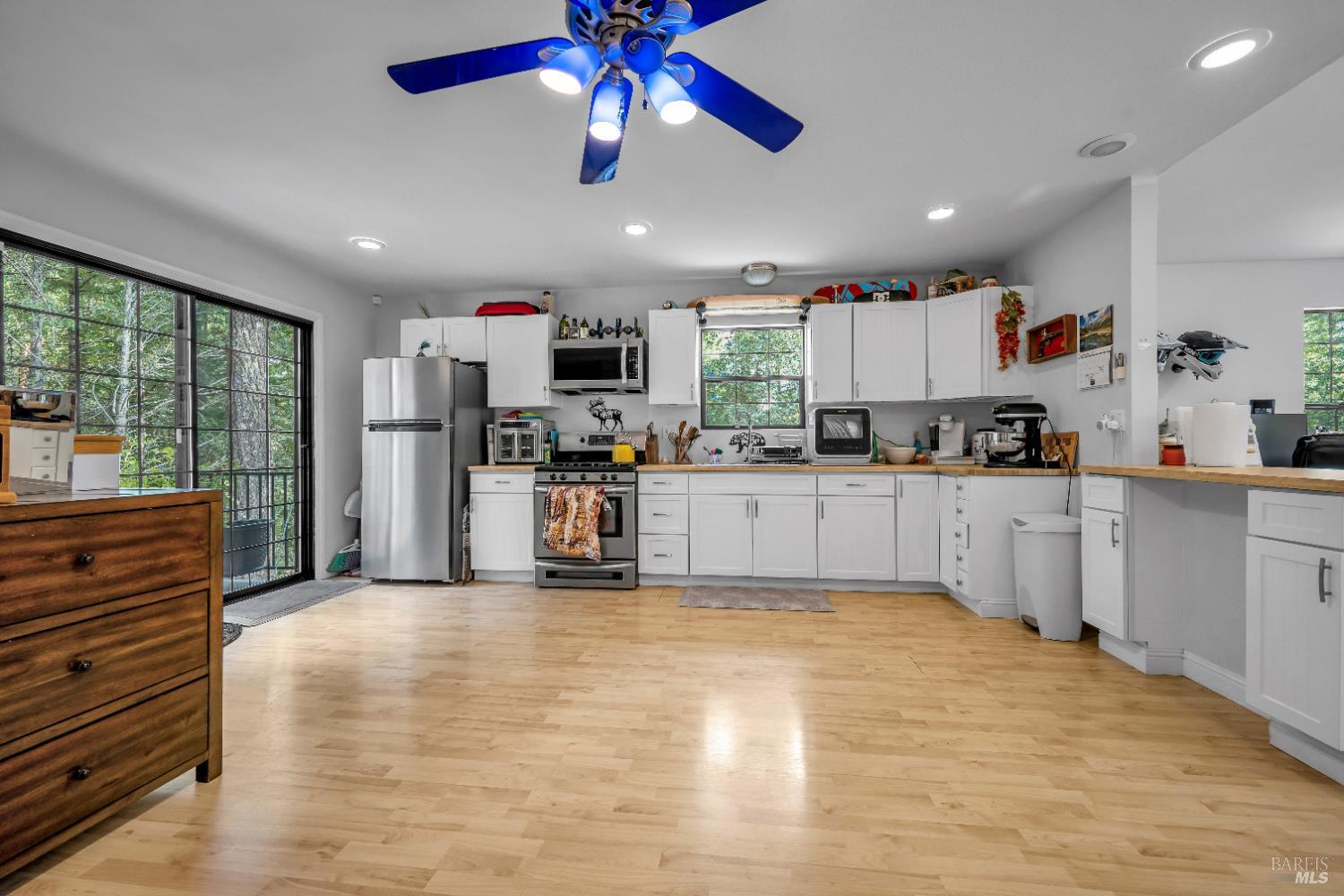 22945 Ridge Road Willits, CA 95490 - Photo 32 of 48 a kitchen with stainless steel appliances kitchen island granite countertop a refrigerator and microwave