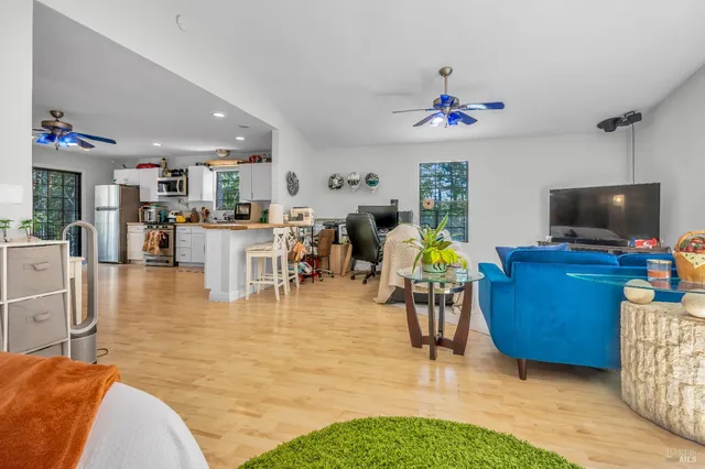 a view of a livingroom with furniture and a flat screen tv