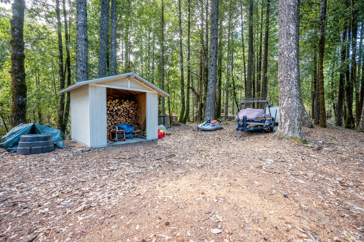 22945 Ridge Road Willits, CA 95490 - Photo 43 of 48 a car parked in front of a house with a yard