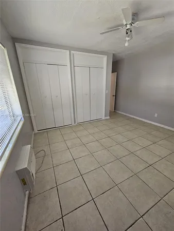 a view of a house with a yard and large tree