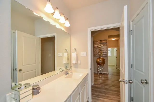 a en suite bathroom with a double vanity sink mirror and shower