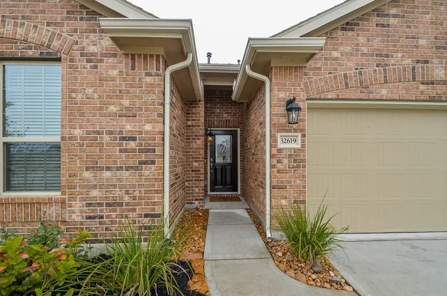 a couple of potted plants in front of door
