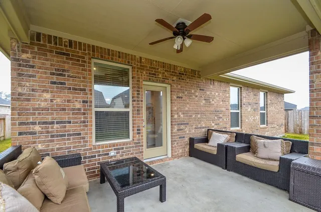 a view of a house with backyard and porch