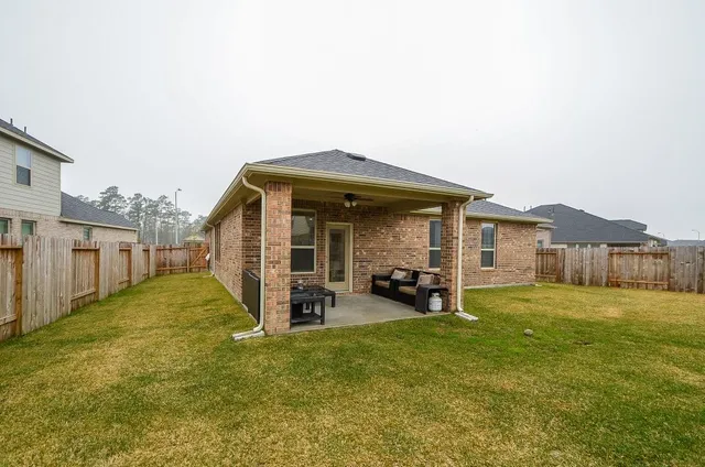 a view of a house with a yard and porch
