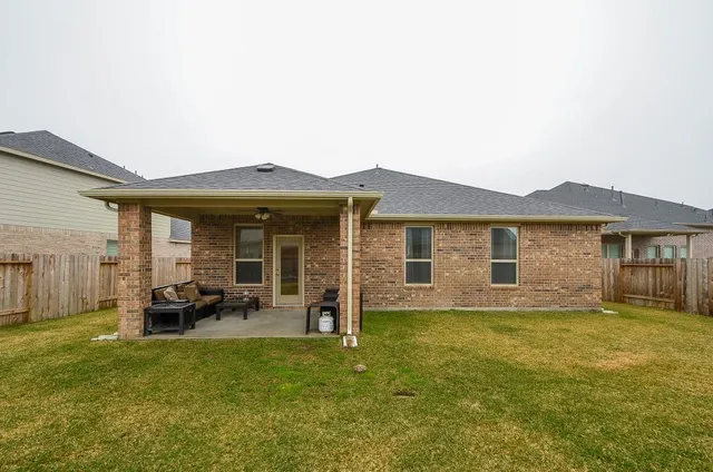 a view of a house with a yard and sitting area