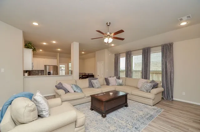 a living room with furniture and a large window
