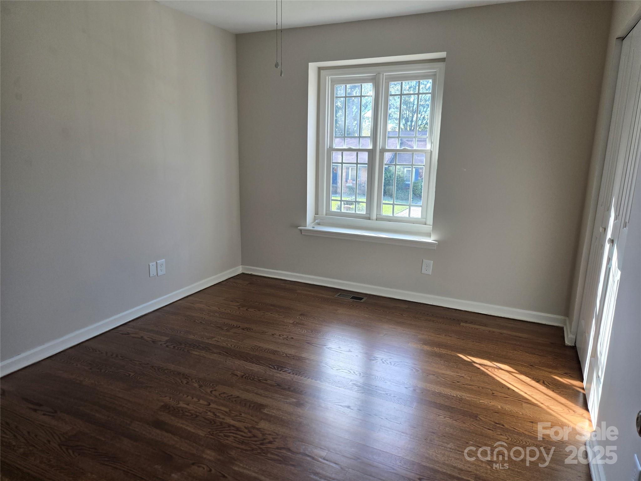 7214 Fox Hunt Road Charlotte, NC 28212 - Photo 11 of 24 an empty room with wooden floor and windows