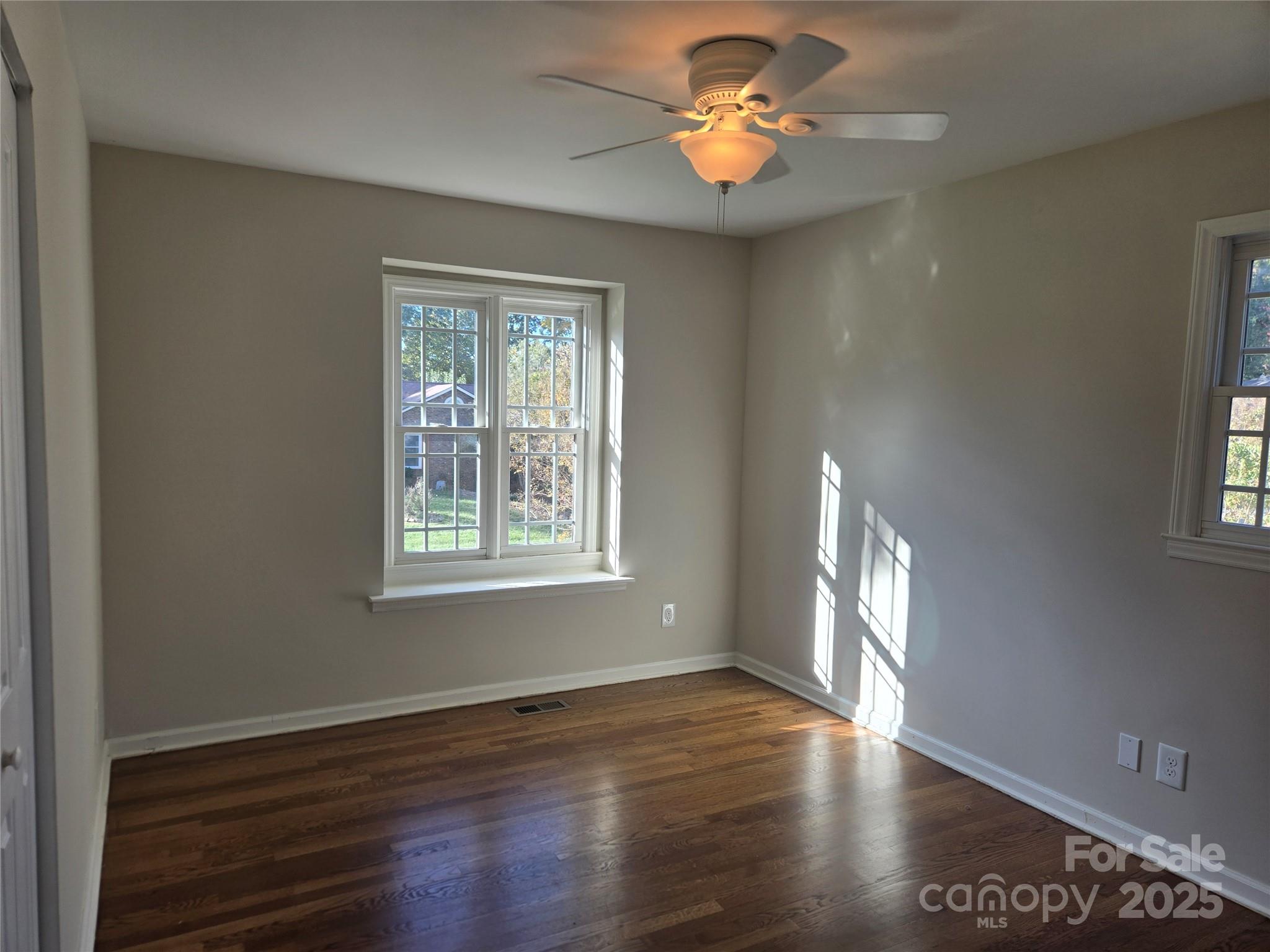 7214 Fox Hunt Road Charlotte, NC 28212 - Photo 12 of 24 a view of an empty room with a window and wooden floor