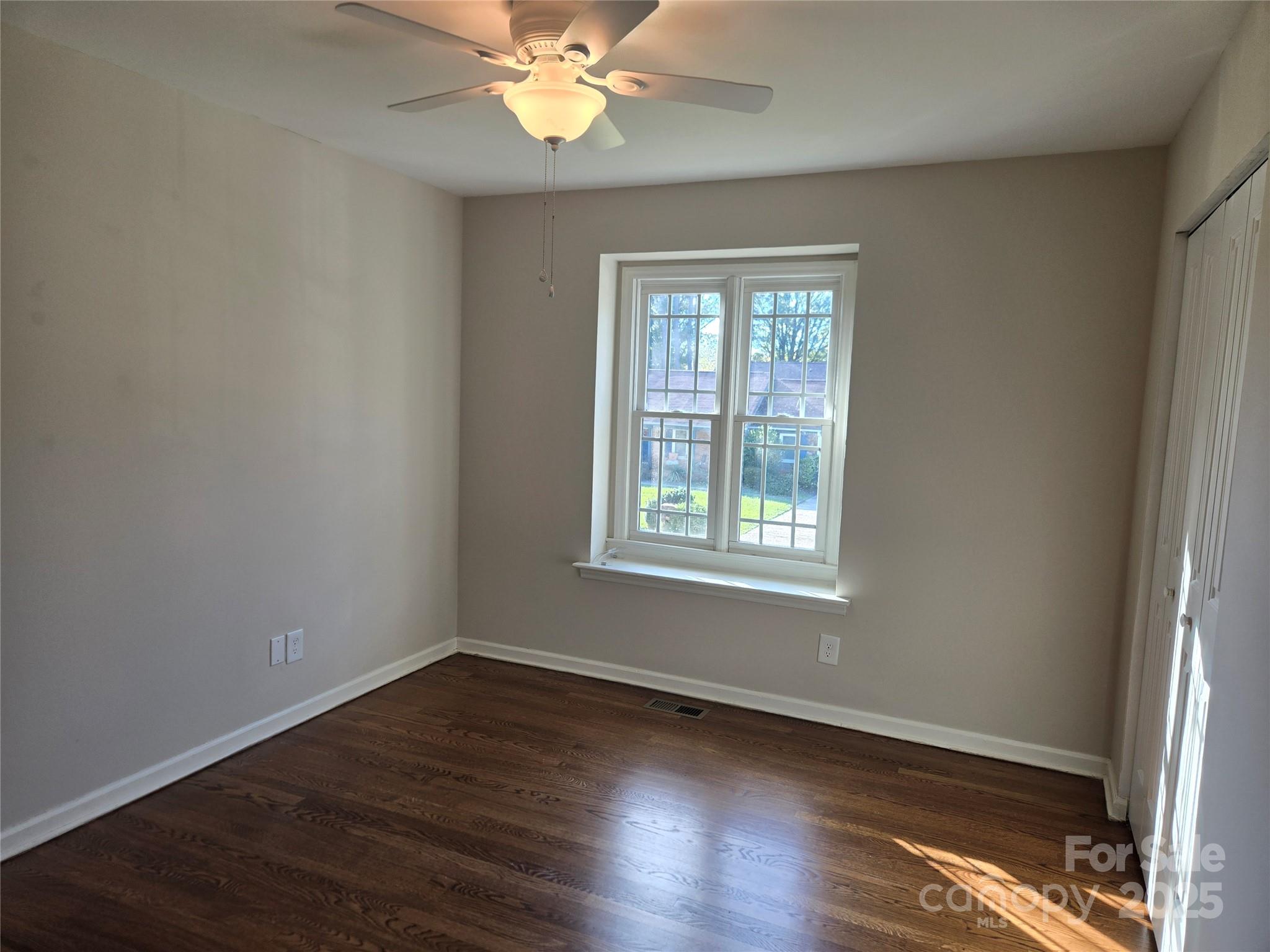 7214 Fox Hunt Road Charlotte, NC 28212 - Photo 13 of 24 a view of an empty room with wooden floor and a window
