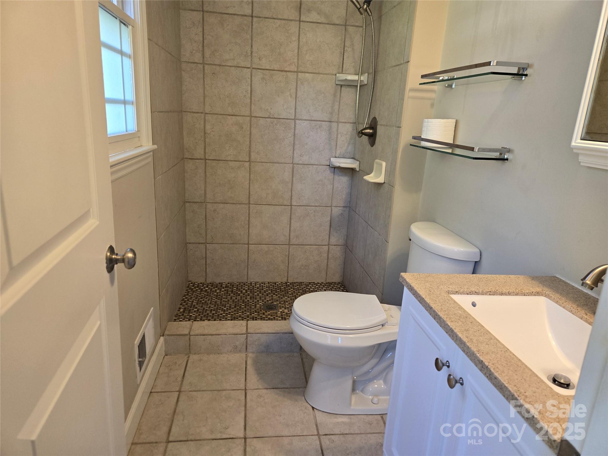 7214 Fox Hunt Road Charlotte, NC 28212 - Photo 15 of 24 a bathroom with a sink and toilet