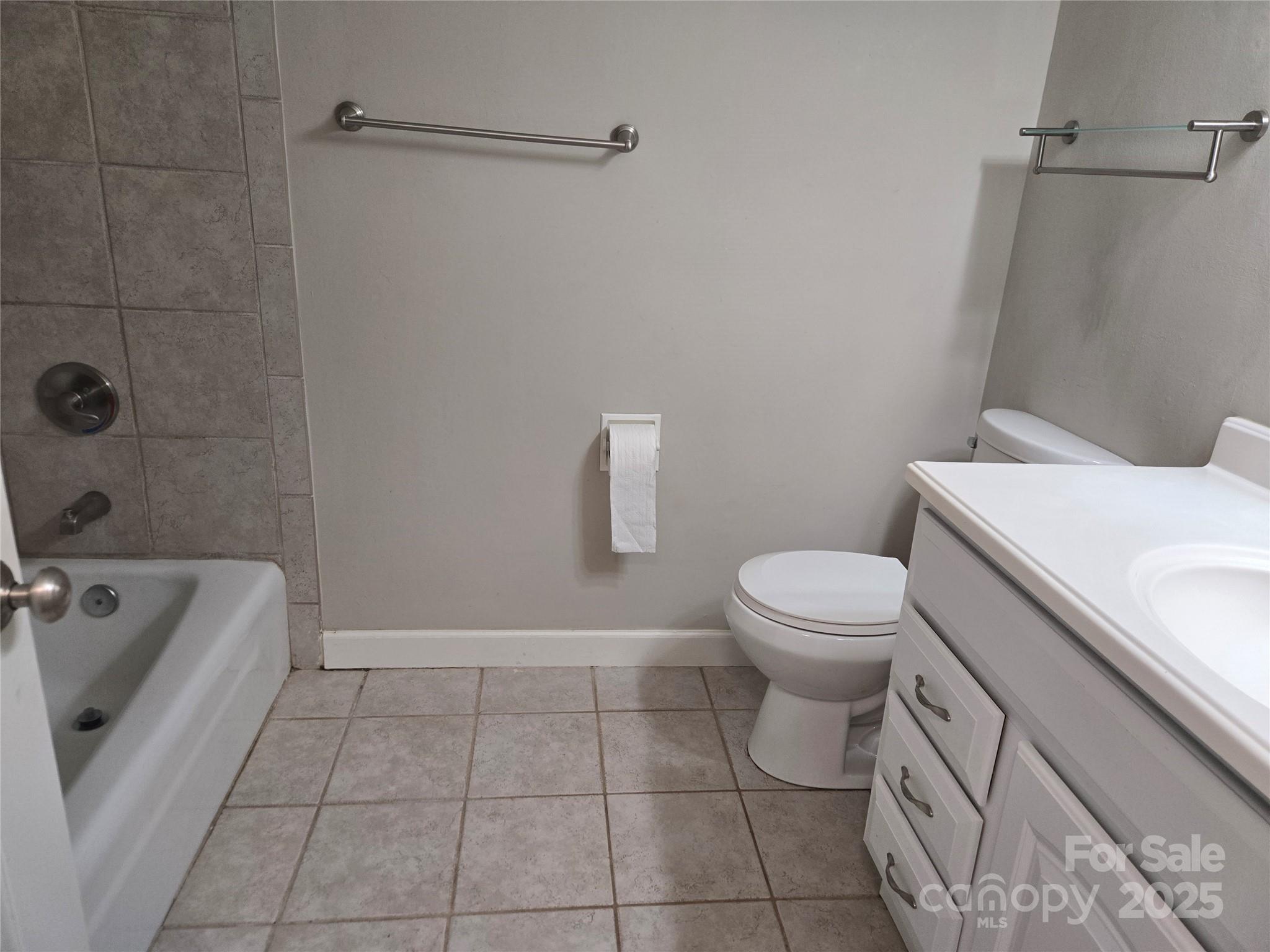 7214 Fox Hunt Road Charlotte, NC 28212 - Photo 16 of 24 a bathroom with a sink a toilet and shower