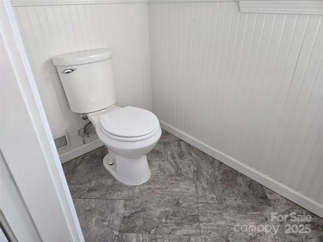 a white toilet sitting in a bathroom