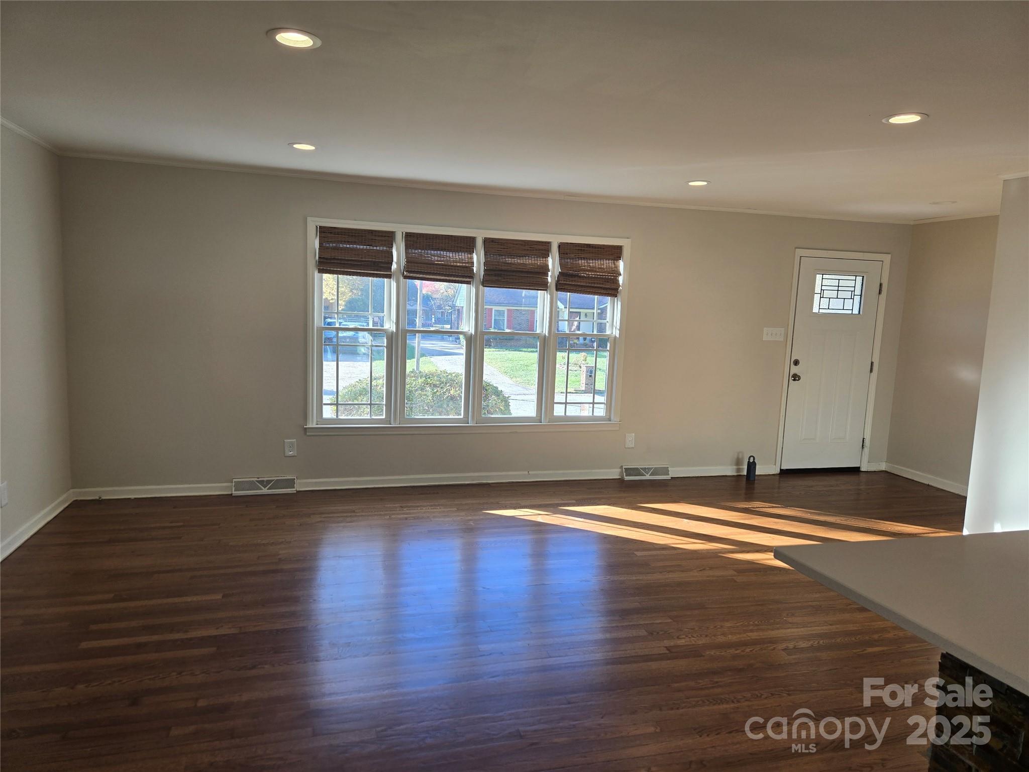 7214 Fox Hunt Road Charlotte, NC 28212 - Photo 5 of 24 a view of empty room with wooden floor and fan
