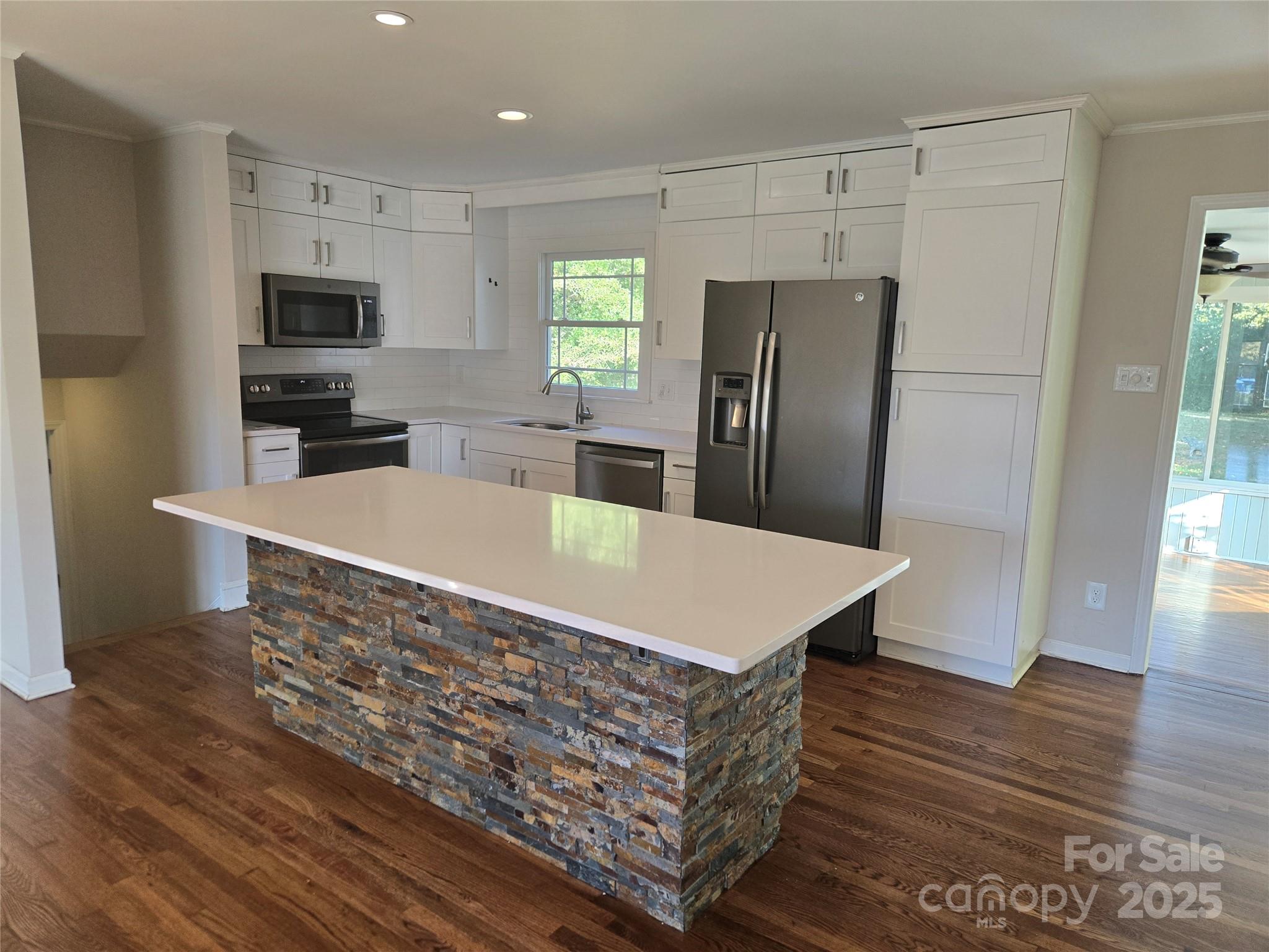 7214 Fox Hunt Road Charlotte, NC 28212 - Photo 6 of 24 a kitchen with stainless steel appliances a refrigerator and wooden floor