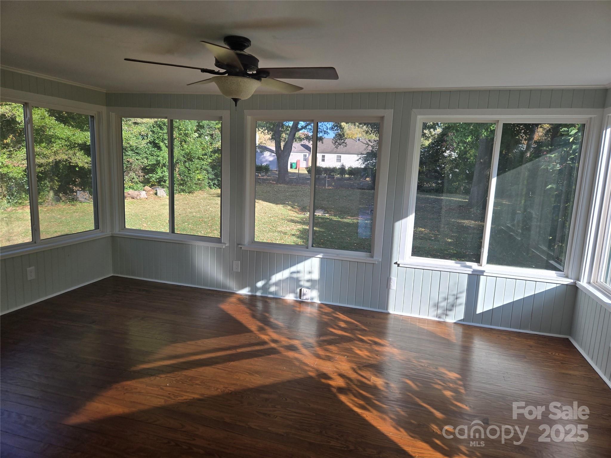 7214 Fox Hunt Road Charlotte, NC 28212 - Photo 9 of 24 a view of empty room with wooden floor and fan