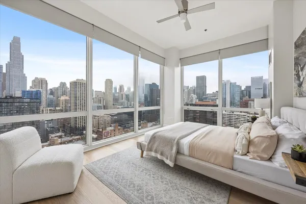 a bedroom with a bed and glass walk in closet
