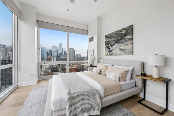 a bedroom with a bed and a large window