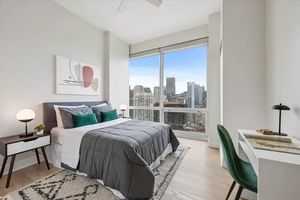 a bedroom with a bed and a large window