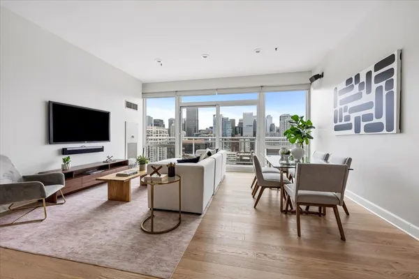 a living room with patio furniture and a flat screen tv