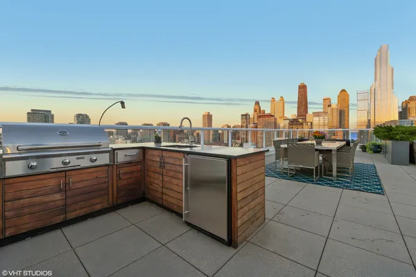 a kitchen with stainless steel appliances granite countertop a sink and a stove
