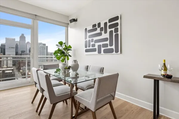 a dining room with furniture and wooden floor